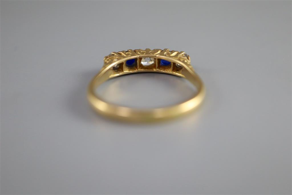 An early/mid 20th century 18ct gold and platinum, two stone sapphire and three stone diamond half hoop ring,